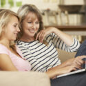 Mother With Teenage Daughter looking at laptop